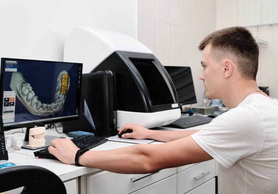 Dental technician working with a computer in a laboratory. 3D modeling of the crown in the dental lab. Workplace dental technician.; Shutterstock ID 2266351525; purchase_order: -; job: -; client: -; other: -